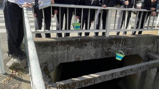 Conducting water quality monitoring at the Hirase River.