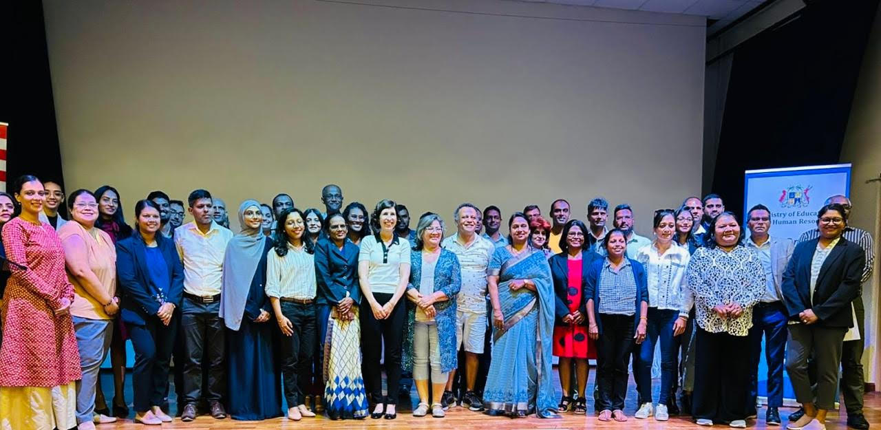 Large group of people posing for photo.
